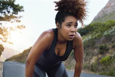 Young woman stopped midrun to take a break Young woman stopped midrun to take a break