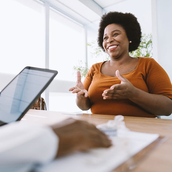 Woman speaking with a doctor in an office.