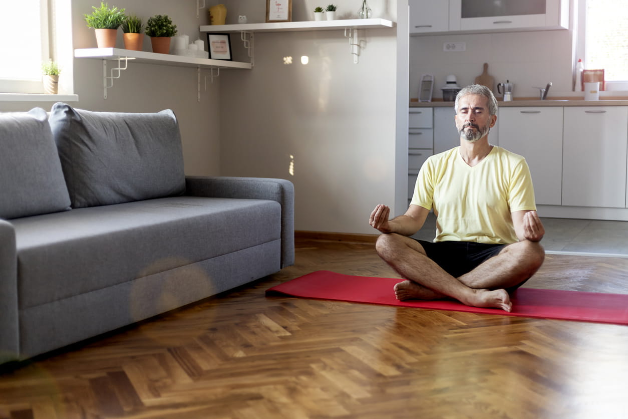 Man meditating on a yoga mat